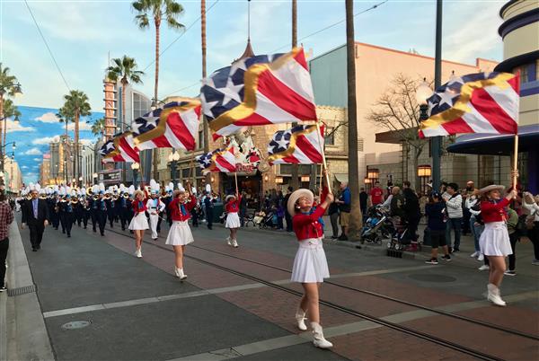 High school flag bearers march at Disney California Adventure amusement park High school flag bearers march at Disney California Adventure amusement park